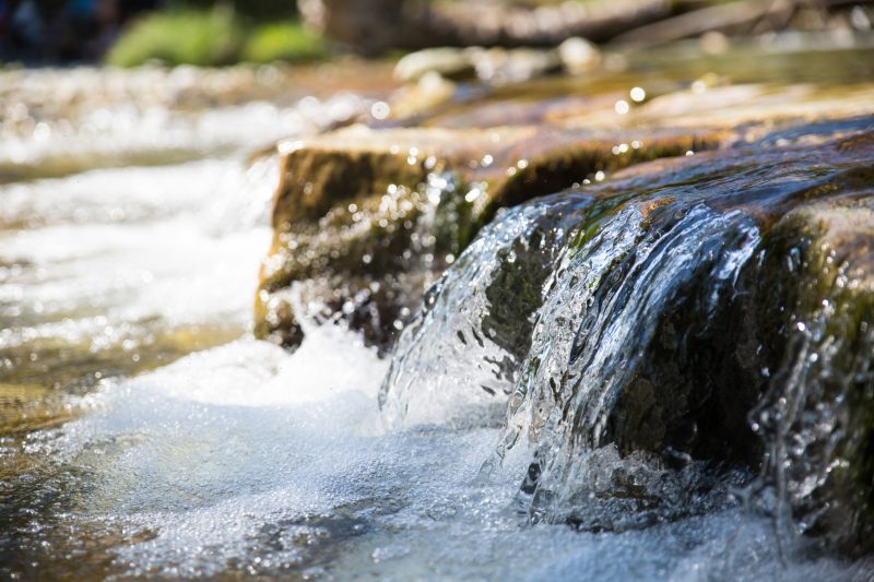 Follow a running stream of water downstream