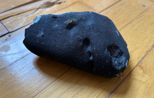 Chunk of meteorite on a hardwood floor